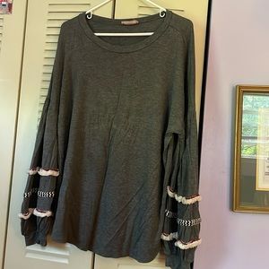 Dark grey long sleeve with details on bottom sleeve